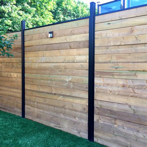 shadow box fence combined with a black metal garden fence|lowe's shadow box fencing panels.